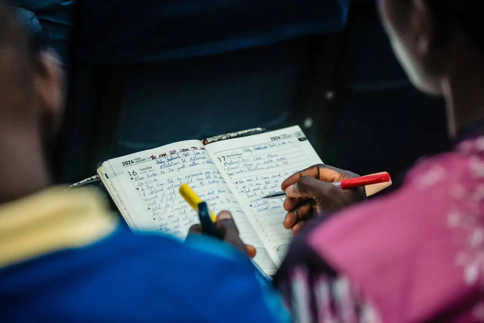 People engaging in a focused Bible study session, sharing notes and insights.